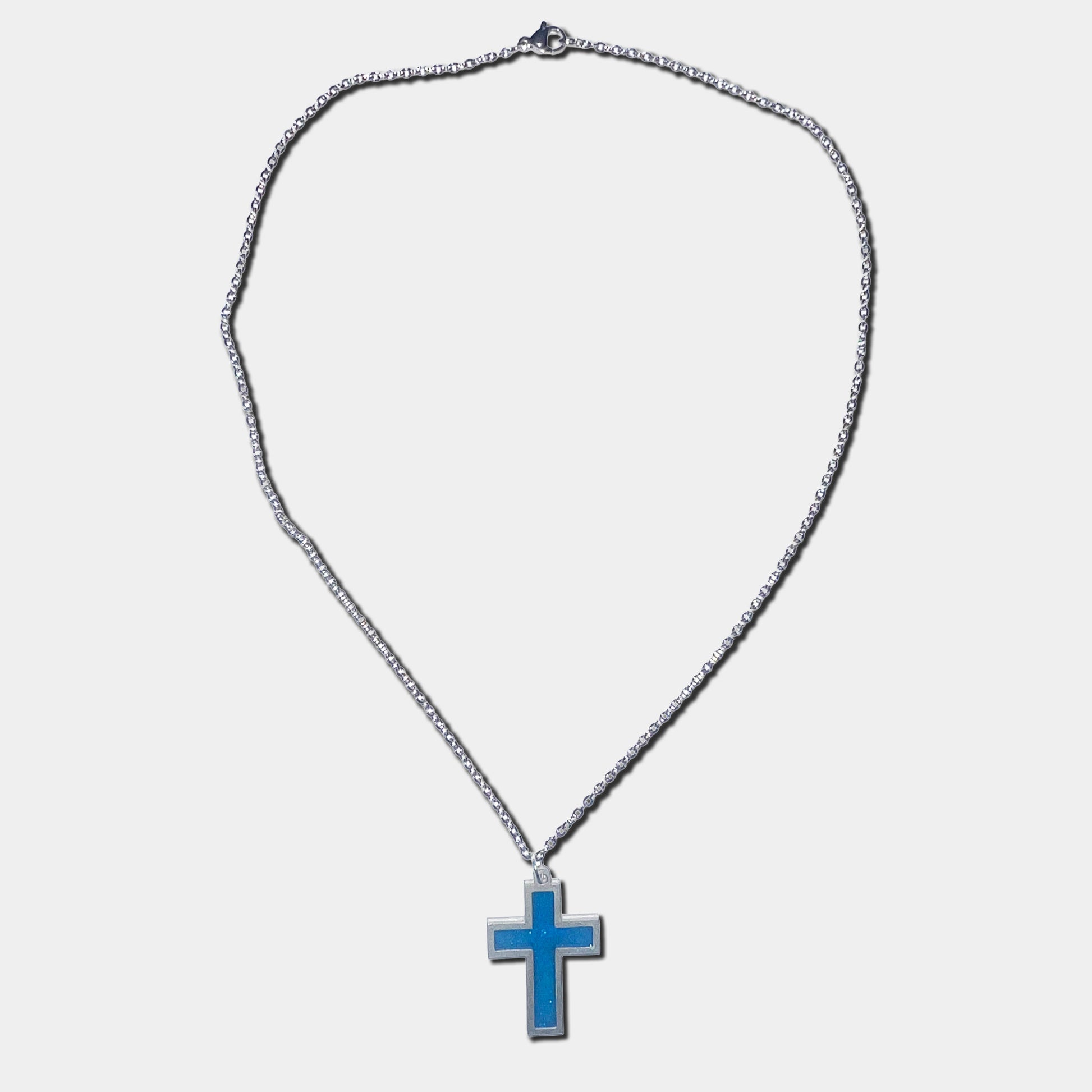 Stainless steel necklace with blue cross pendant on a white background