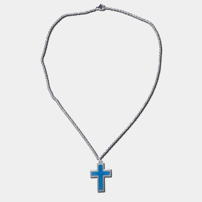 Stainless steel necklace with blue cross pendant on a white background