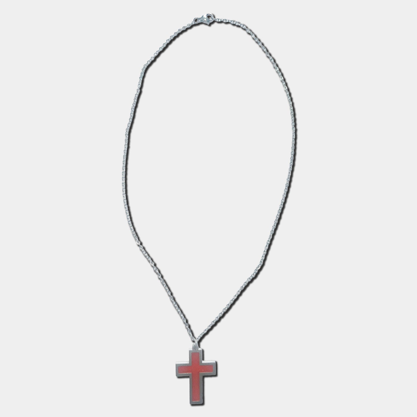 Stainless steel necklace with red cross pendant on a white background