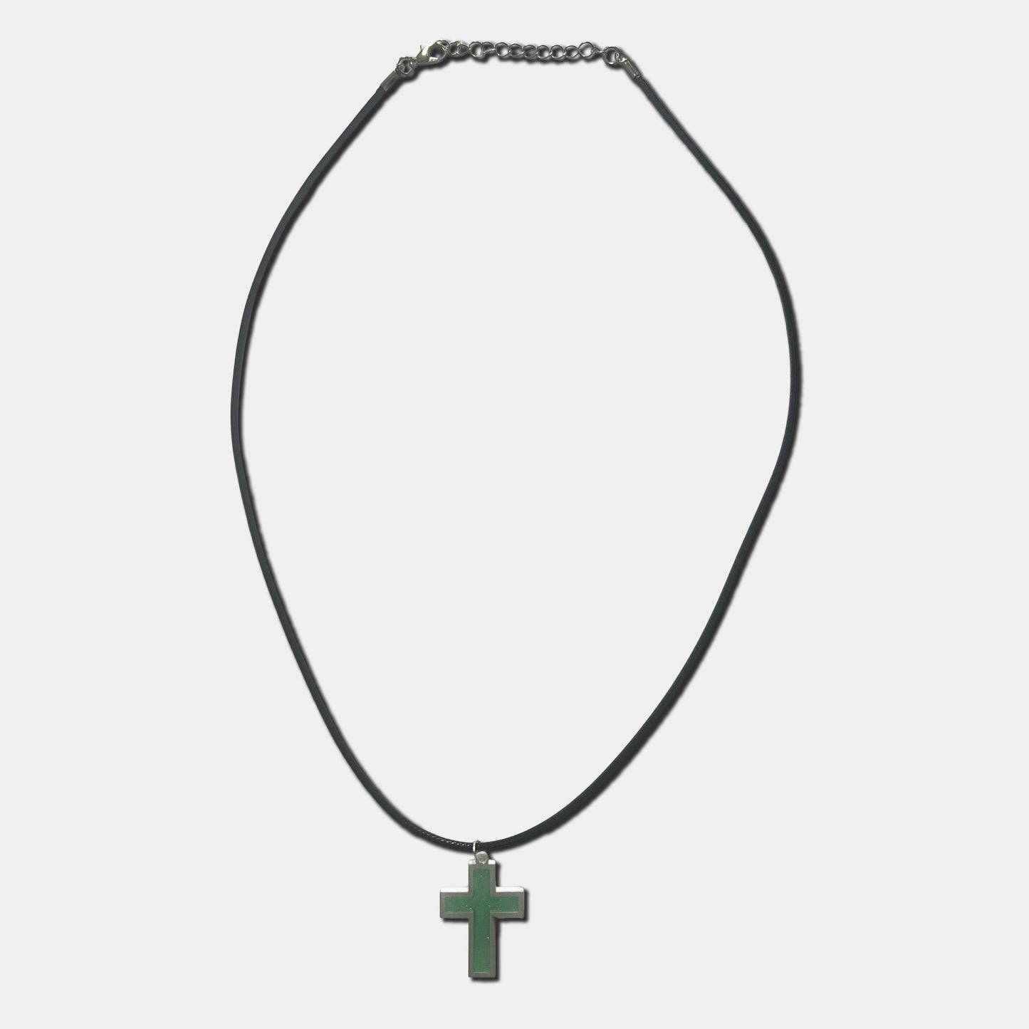Black cord necklace with green cross pendant on a white background