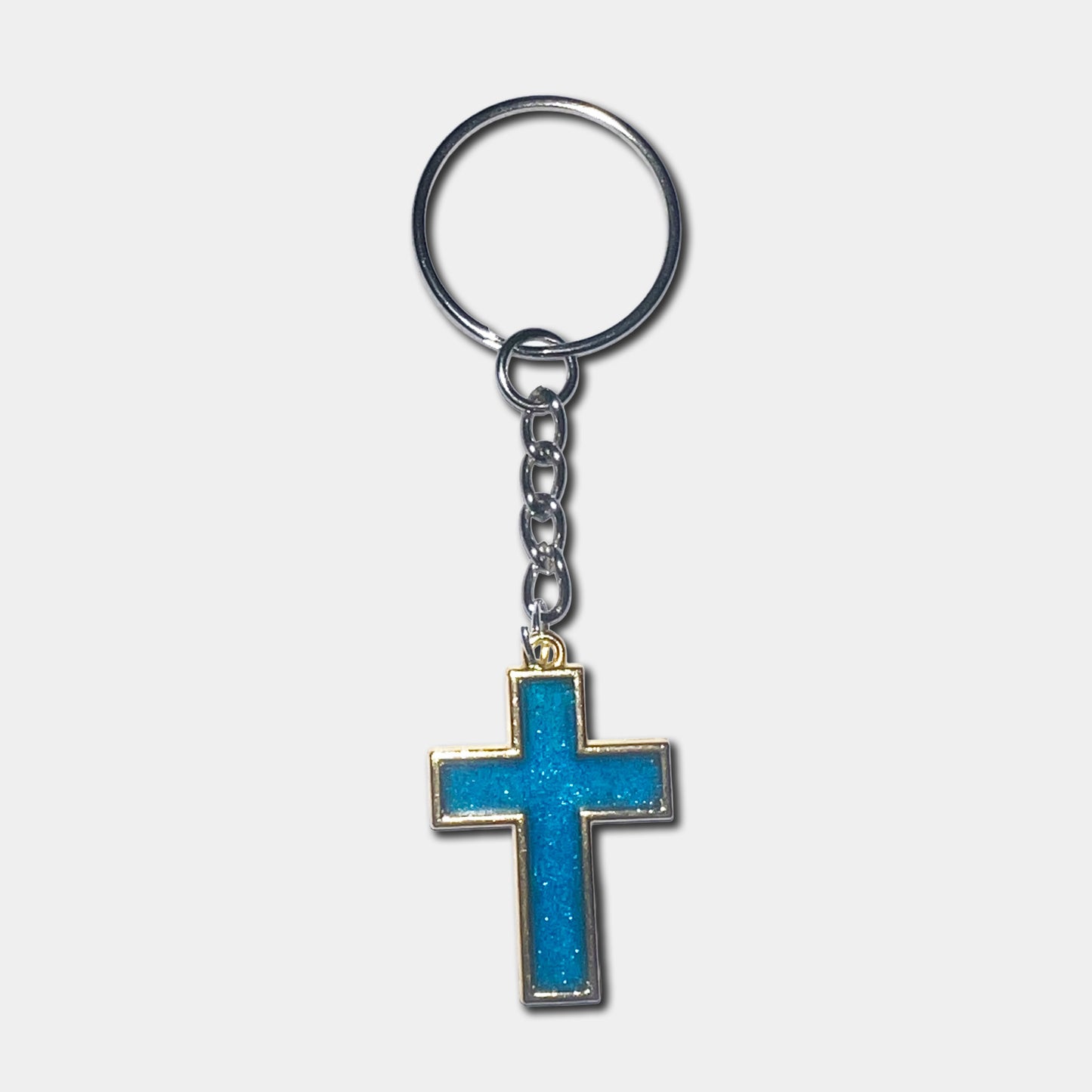 Keychain with a blue cross pendant on a light gray background