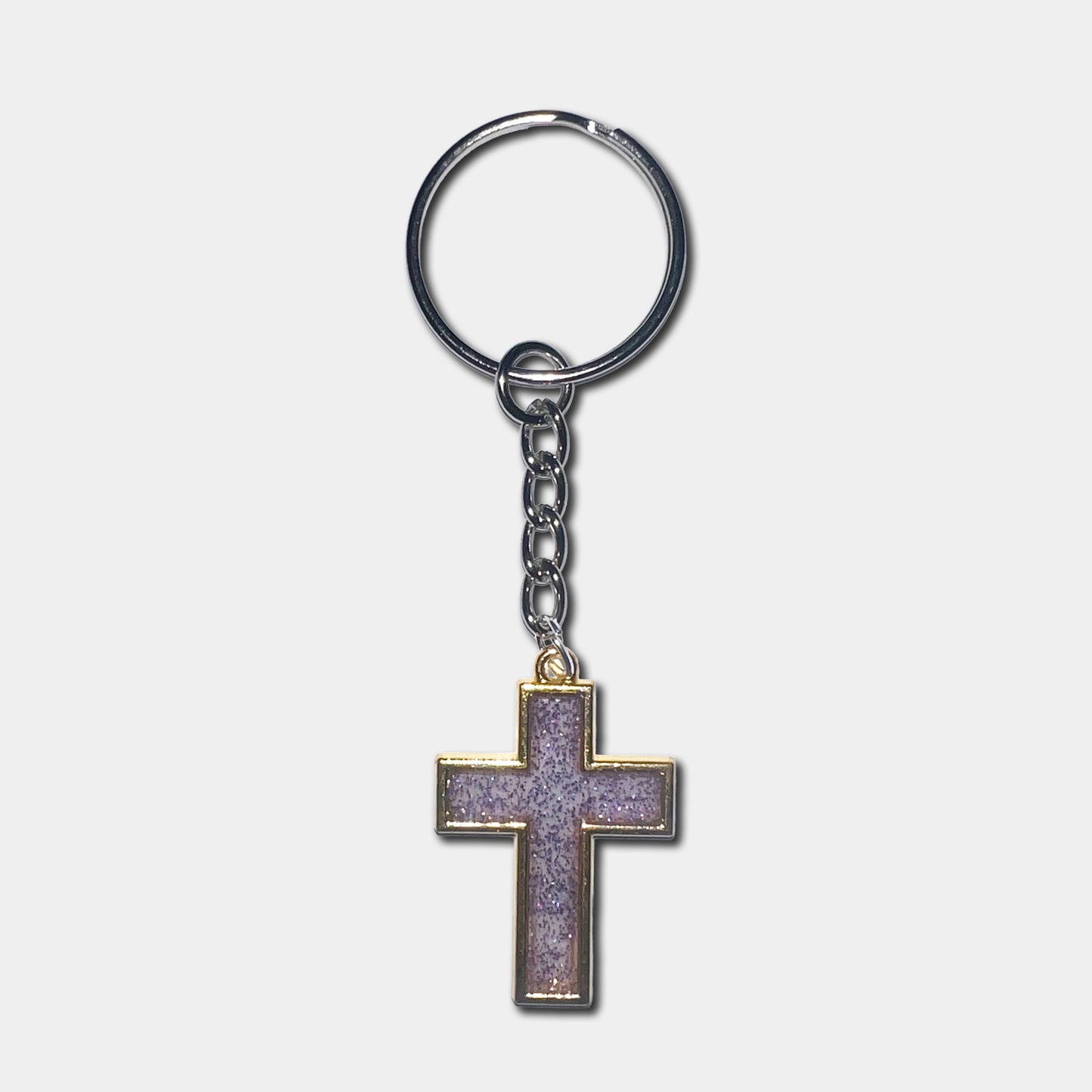 Keychain with a purple cross pendant on a light gray background