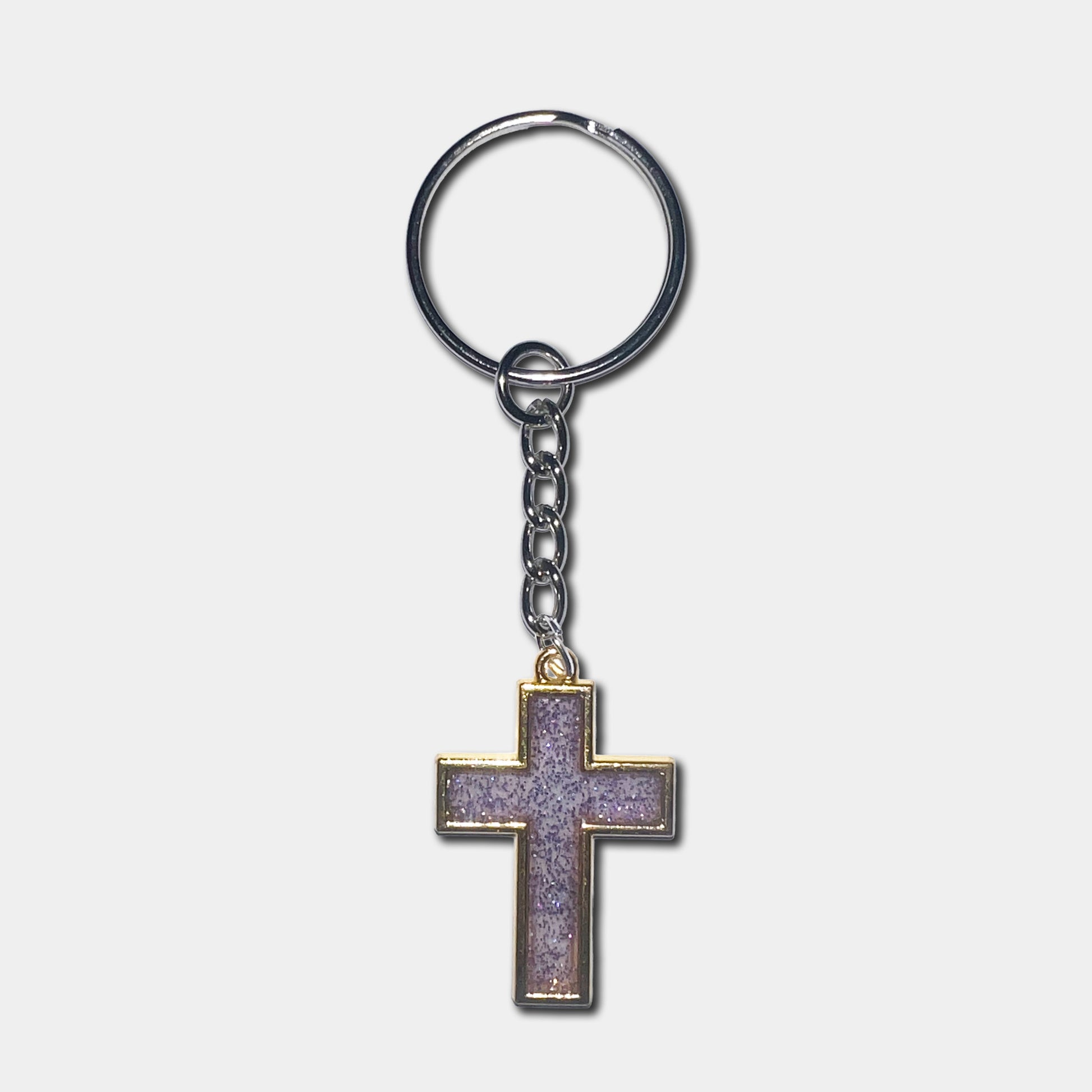 Keychain with a purple cross pendant on a light gray background