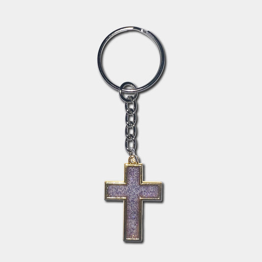Keychain with a purple cross pendant on a light gray background