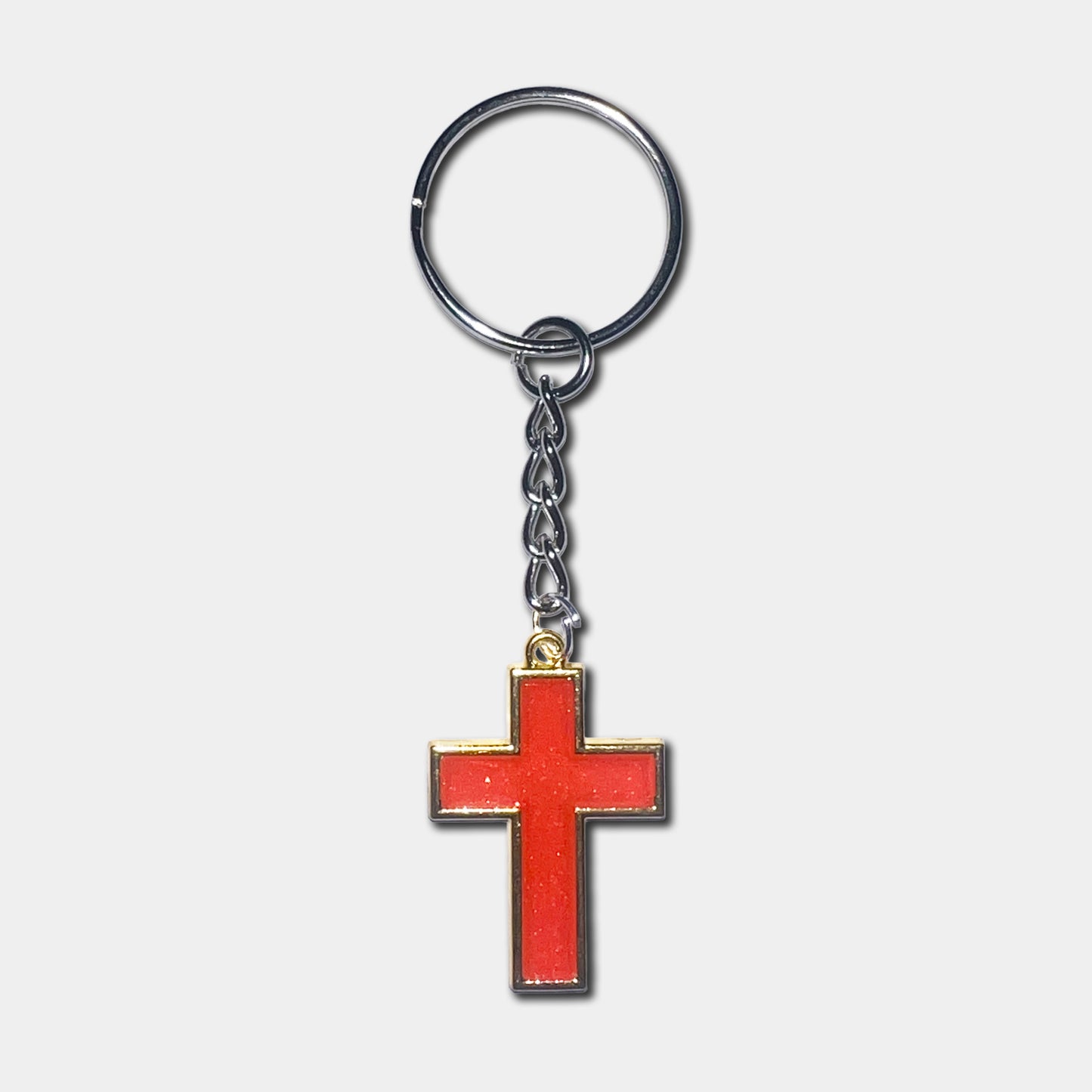 Keychain with a red cross pendant on a light gray background
